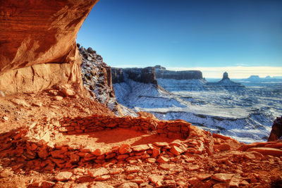 Rock formations in sea against sky