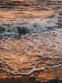 Scenic view of sea waves during sunset