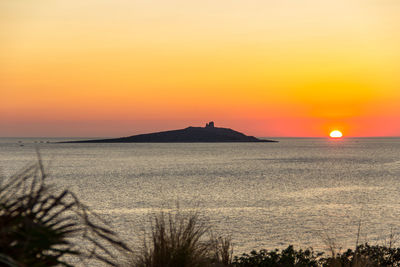 Scenic view of sea against romantic sky at sunset