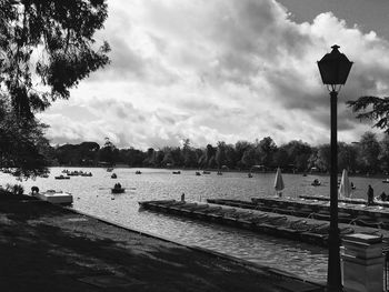 Street by lake against sky