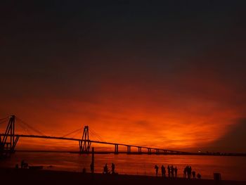 Silhouette people on beach against sky during sunset. corrientes capital argentina 