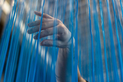 Close-up of man hand holding wire