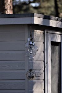 Close-up of light bulb hanging on wall