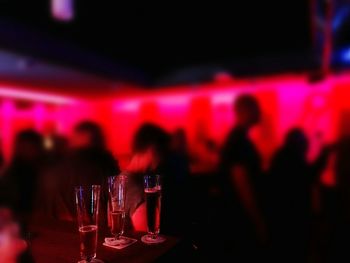Close-up of red wine in glass at night