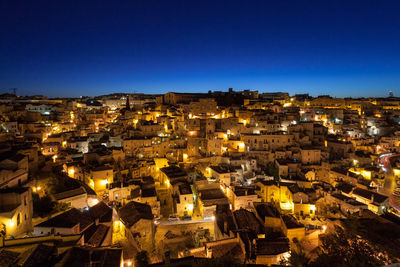 High angle view of illuminated buildings in city at night
