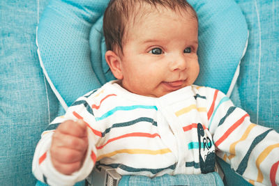 Cute baby girl on bed at home