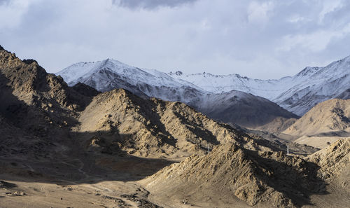 Beautiful landscape of mountains with sun over them in ladakh. captured during snowfall.