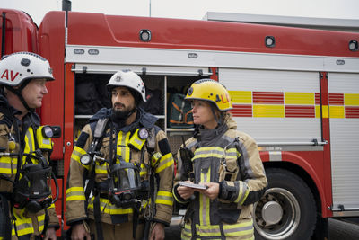 Firefighters in front of fire engine