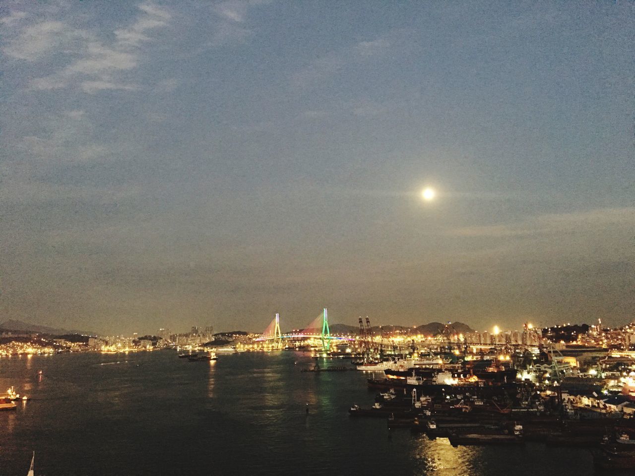 ILLUMINATED CITYSCAPE AGAINST SKY AT NIGHT