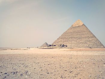 Pyramid in the desert against clear sky