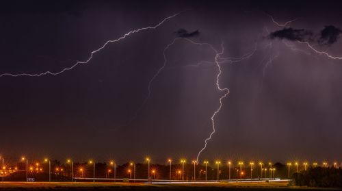 Panoramic view of lightning in sky at night