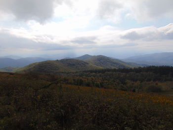 Scenic view of mountains against cloudy sky