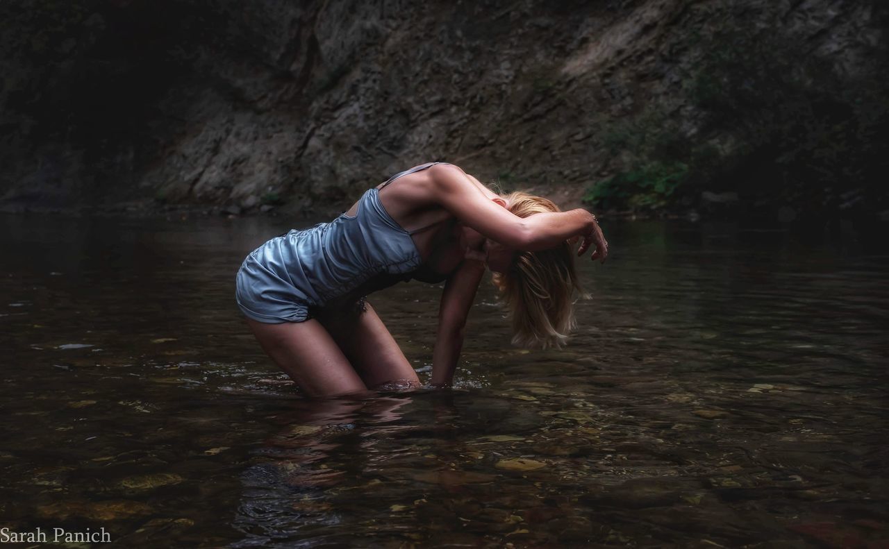 WOMAN STANDING IN LAKE