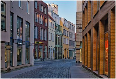 Street amidst buildings against sky