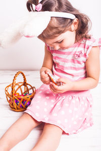 Girl with easter eggs sitting at home