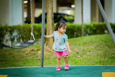 Full length of girl standing at playground