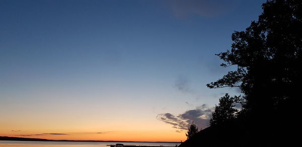 Low angle view of silhouette trees against sky at sunset