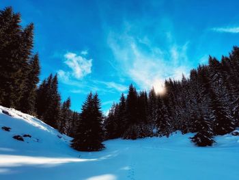 Panoramic view of snow covered mountains against sky