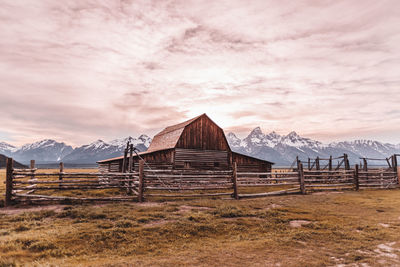 Built structure on field against sky during sunset