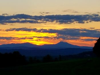 Scenic view of silhouette mountains against sky during sunset