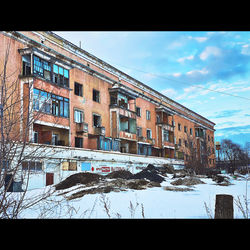 Graffiti on building in city against sky