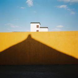 Shadow on surrounding wall against sky