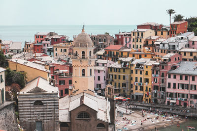 Buildings and church in town against clear sky