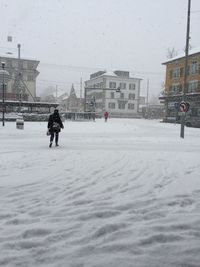 View of snow covered city against sky