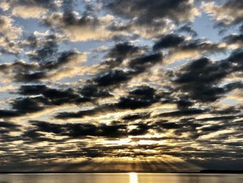 Scenic view of dramatic sky over sea during sunset