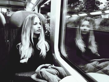 Full length of woman sitting in train