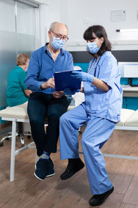 Doctor talking with patient at home