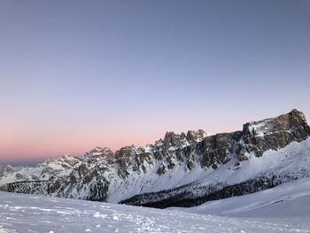 Snowcapped mountains against clear sky during winter