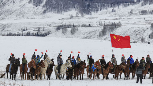 Tuva men competing in a horse racing competition in the altai mountains in china