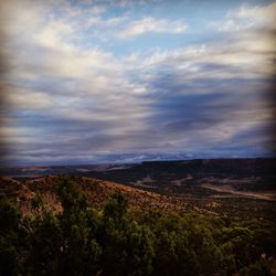 Scenic view of landscape against cloudy sky