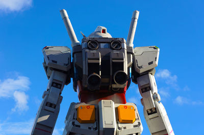 Low angle view of windmill against blue sky