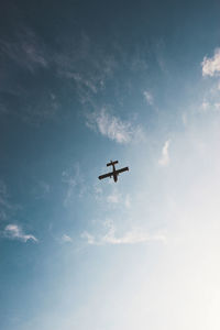 Low angle view of airplane in sky