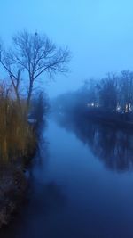 Scenic view of lake against sky during foggy weather