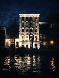 Reflection of illuminated buildings in water at night