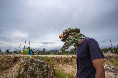 Rear view of man working on field