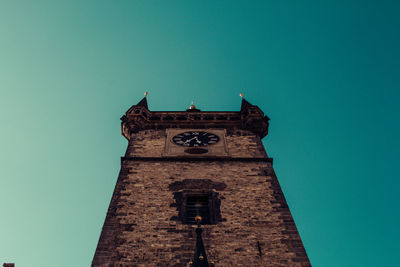 Low angle view of clock tower against blue sky