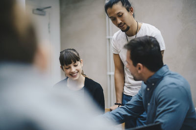 Multi-ethnic computer programmers discussing in office