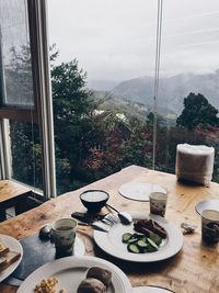 Potted plants on table against window