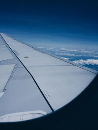 Cropped image of airplane flying over clear sky