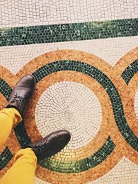 Low section of woman on tiled floor