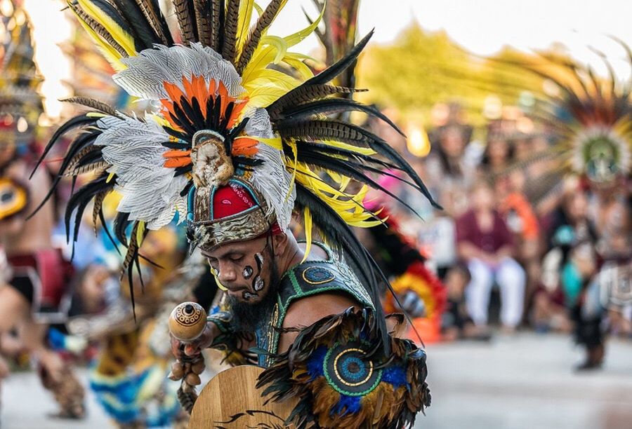 cultures, feather, dancing, traditional clothing, lifestyles, travel destinations, arts culture and entertainment, celebration, tradition, outdoors, mature adult, multi colored, day, close-up, performance, adult, people, crowd, adults only