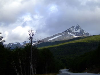 Scenic view of mountains against cloudy sky