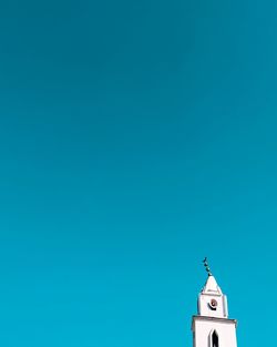 Low angle view of building against clear blue sky