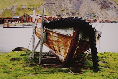 View of an abandoned boat on field