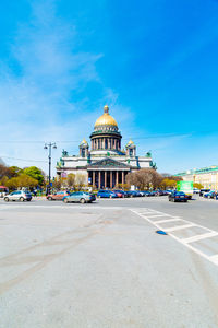 Buildings in city against blue sky