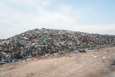 Stack of garbage against stone wall